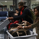 Travelers use the automated screening lanes funded by American Airlines and installed by the Transportation Security Administration at Miami International Airport on Oct. 24, 2017, in Miami.